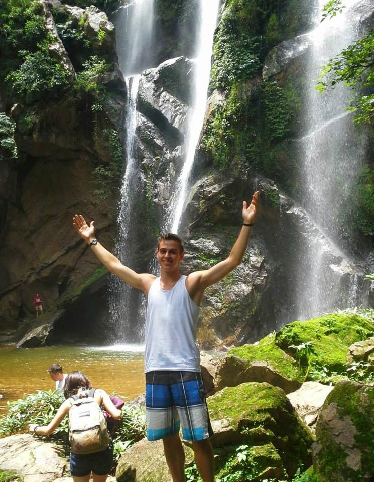 Student in front of waterfall in Chaing Mai Thailand