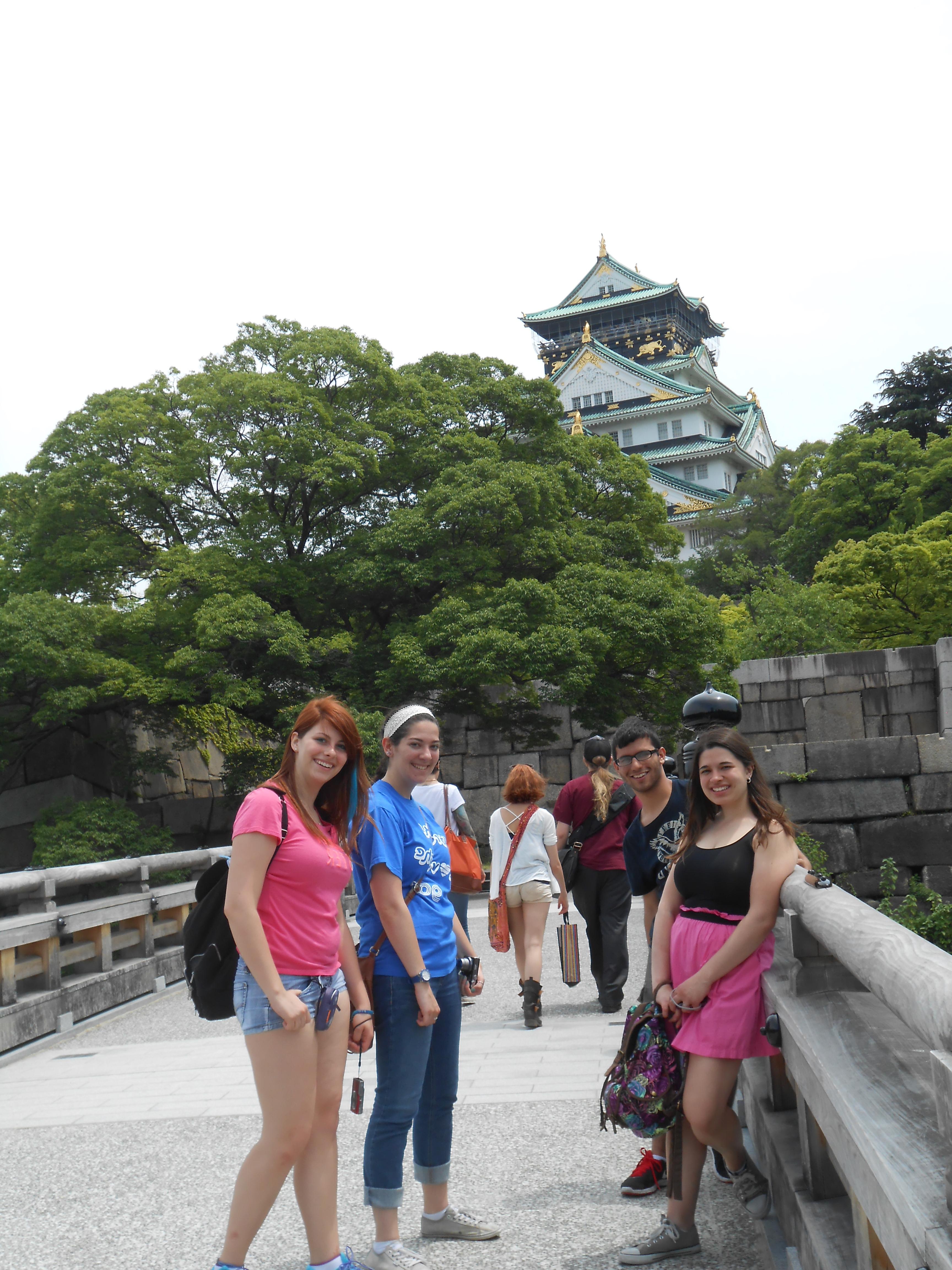 Students on bridge in front of Japanese castle