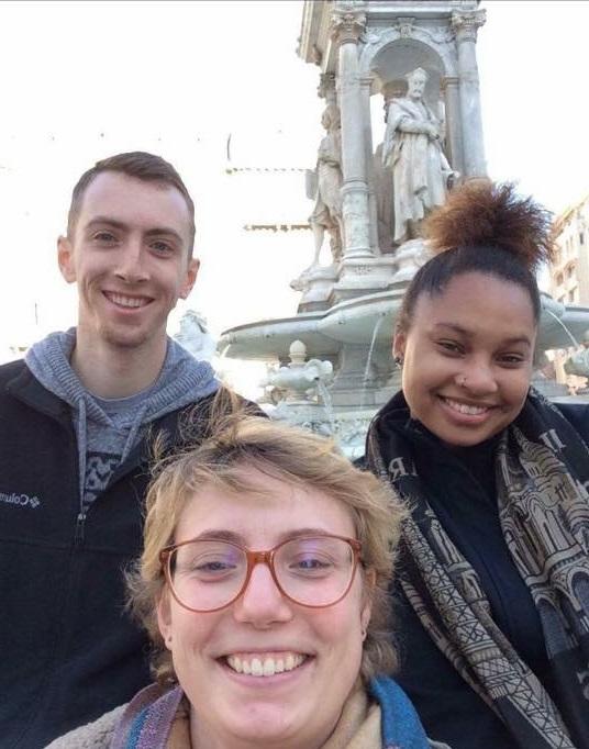 Three students in front of statue in Lyon France