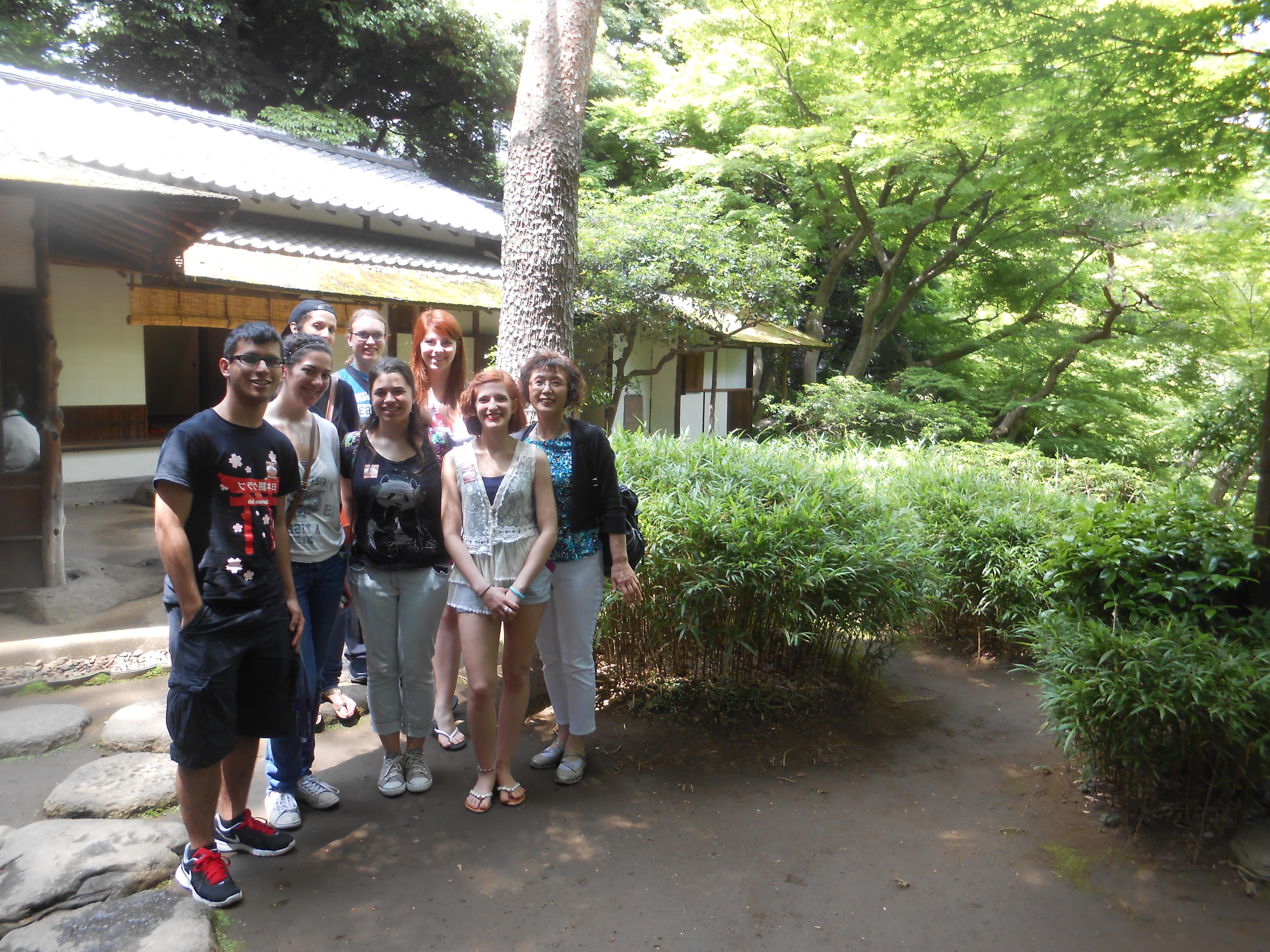 Japanese professor and students in front of teahouse in Japan