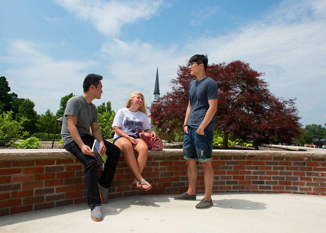 Students sitting on Mount Union's campus.